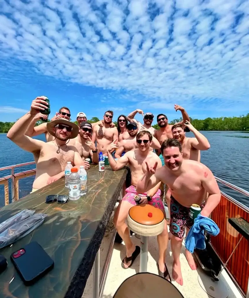 Large bachelor party group celebrating on a private tiki boat cruise in Myrtle Beach